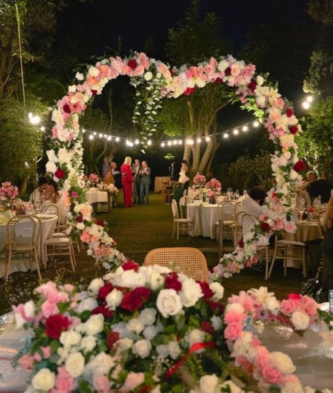Evening reception beneath an illuminated heart arch