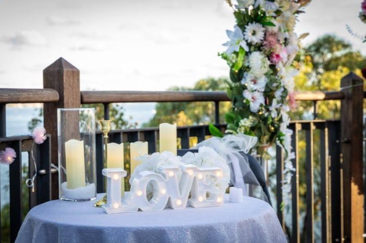Illuminated LOVE letters with candlelit signing table